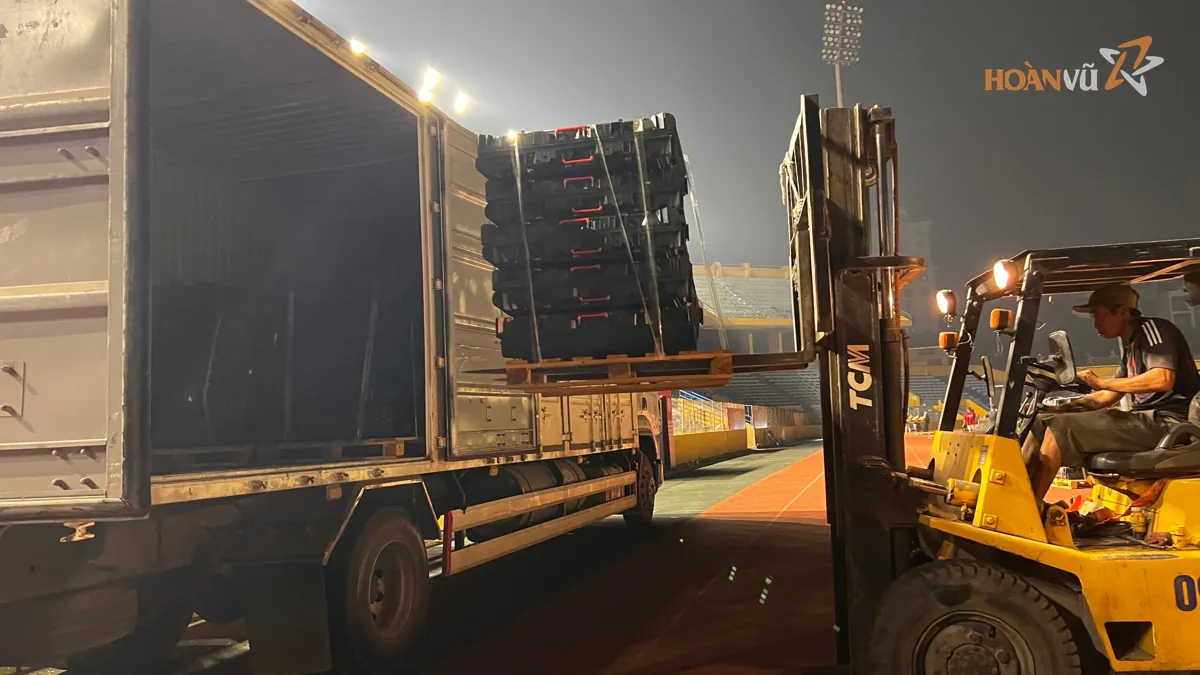 Forklift unloading LED screen cases into a stadium